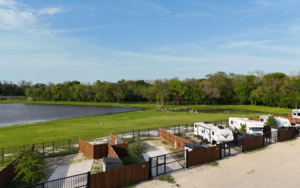 Fenced long-term RV sites with concrete pads and pond views at Holiday Road RV Park in a quiet Texas setting