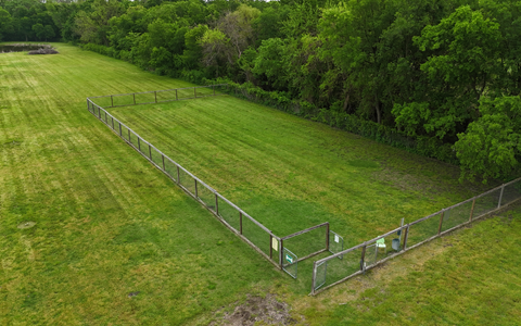 Fenced dog park at Holiday Road RV Park providing a safe off-leash area for pets and long-term RV residents.
